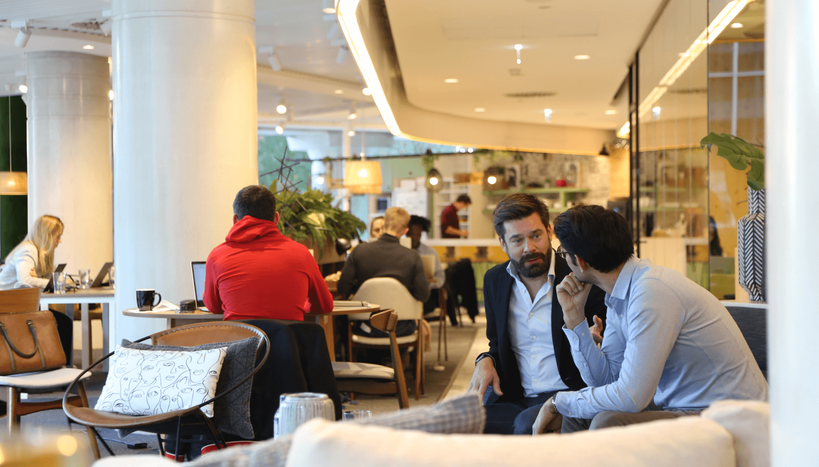 Avila Spaces members communicating in a lounge