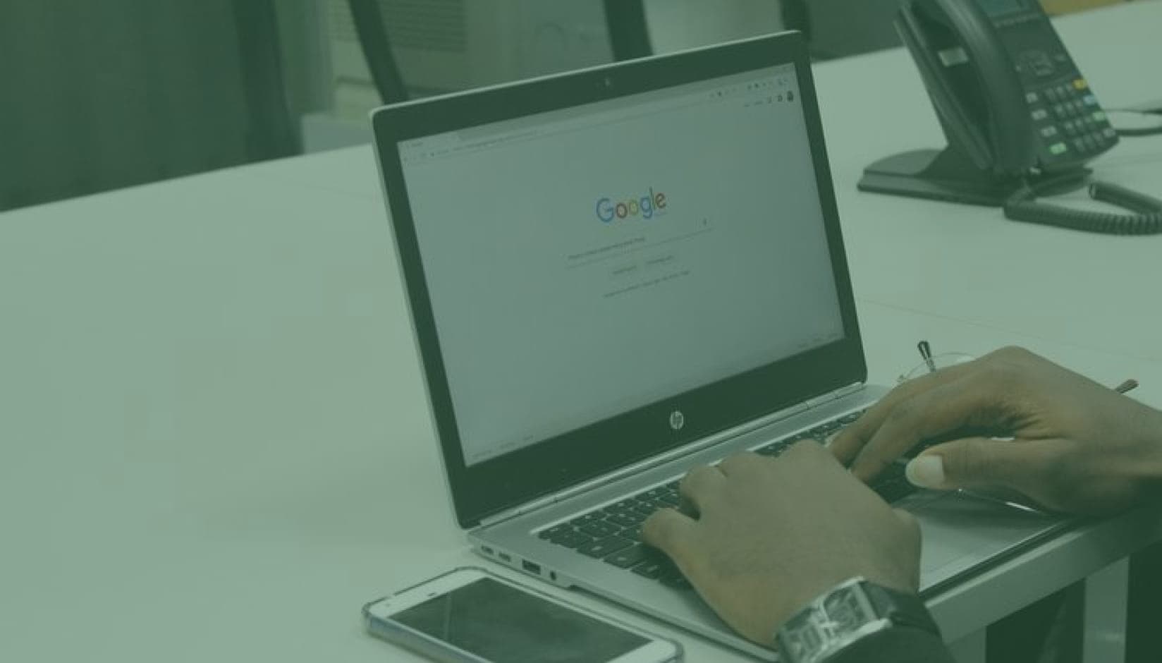 coworking space manager with starting Google page on his laptop
