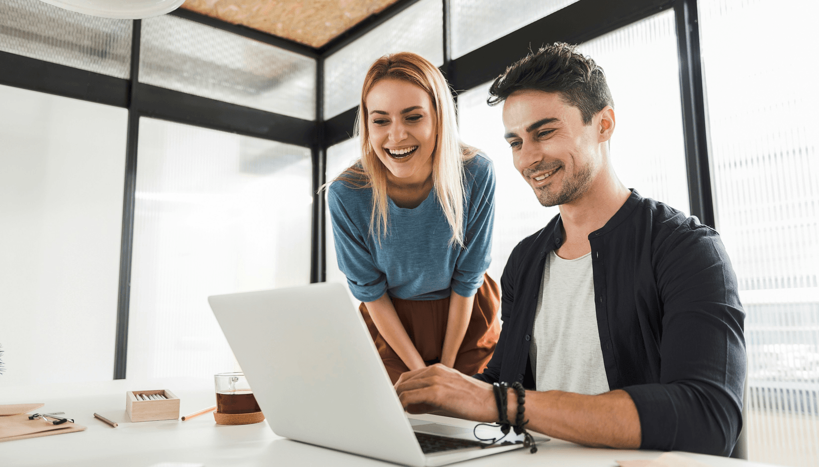 man and woman with a laptop at a coworking space