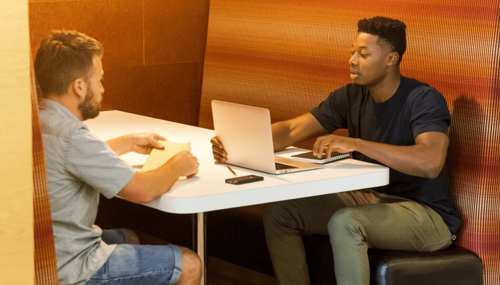 Coworking space members in the phone booth