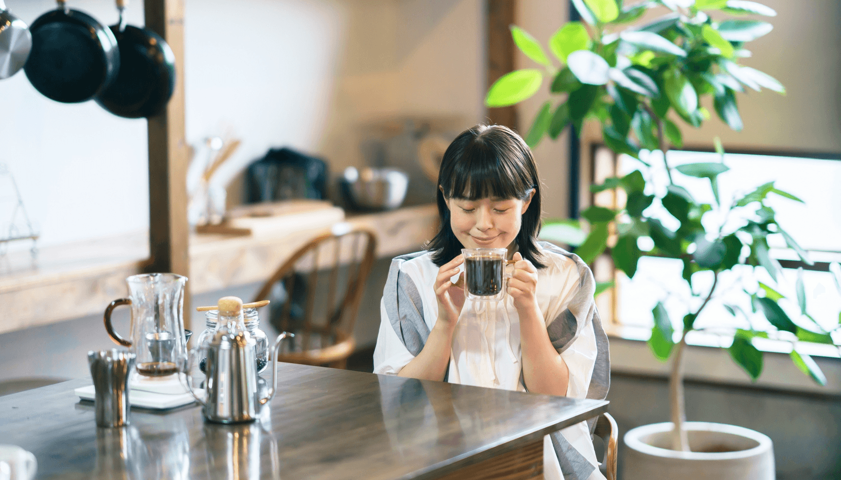 coworking space member with a laptop and a cup of coffee at a virtual coffee-break