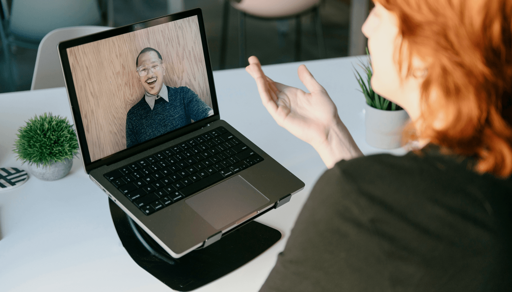 coworking space member using laptop for video call