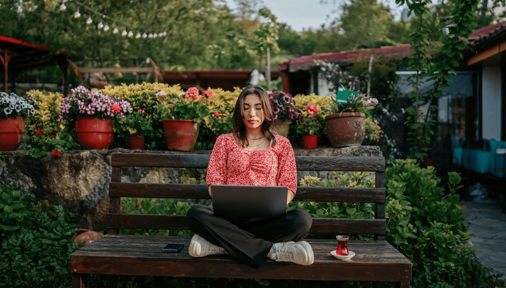 Co-living member with a laptop in the garden 
