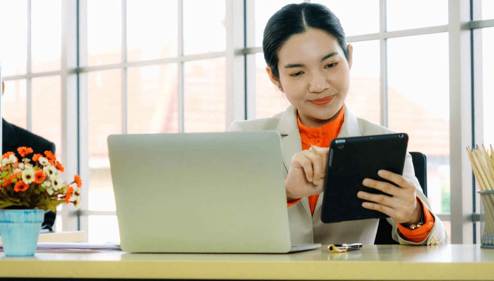 Coworking space manager with laptop and tablet