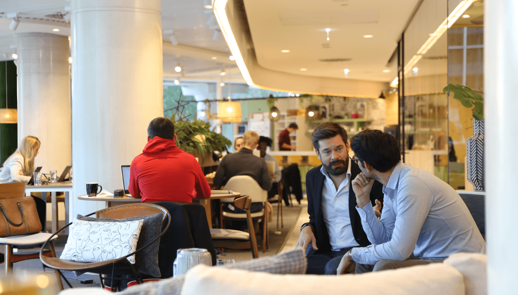 Avila Spaces members communicating in a lounge