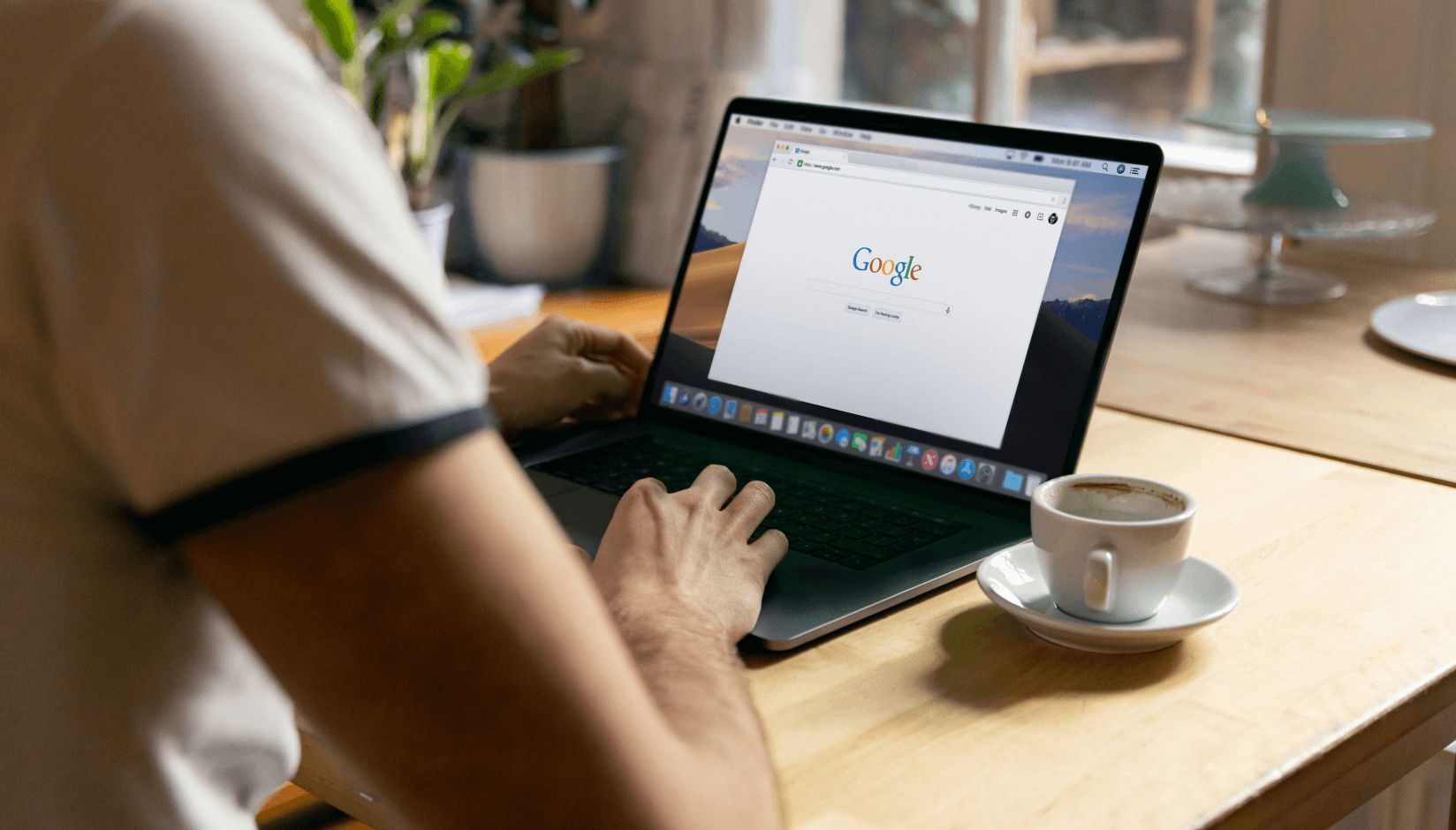 coworking space manager with starting Google page on his laptop
