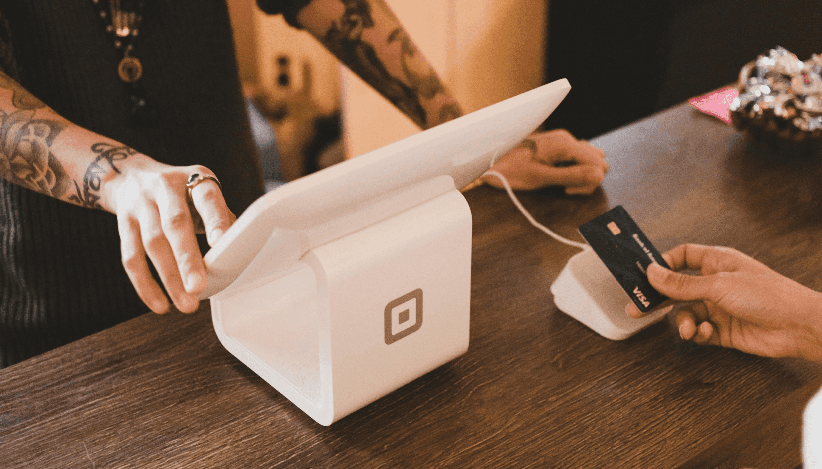 member paying with card at the front desk of a coworking space