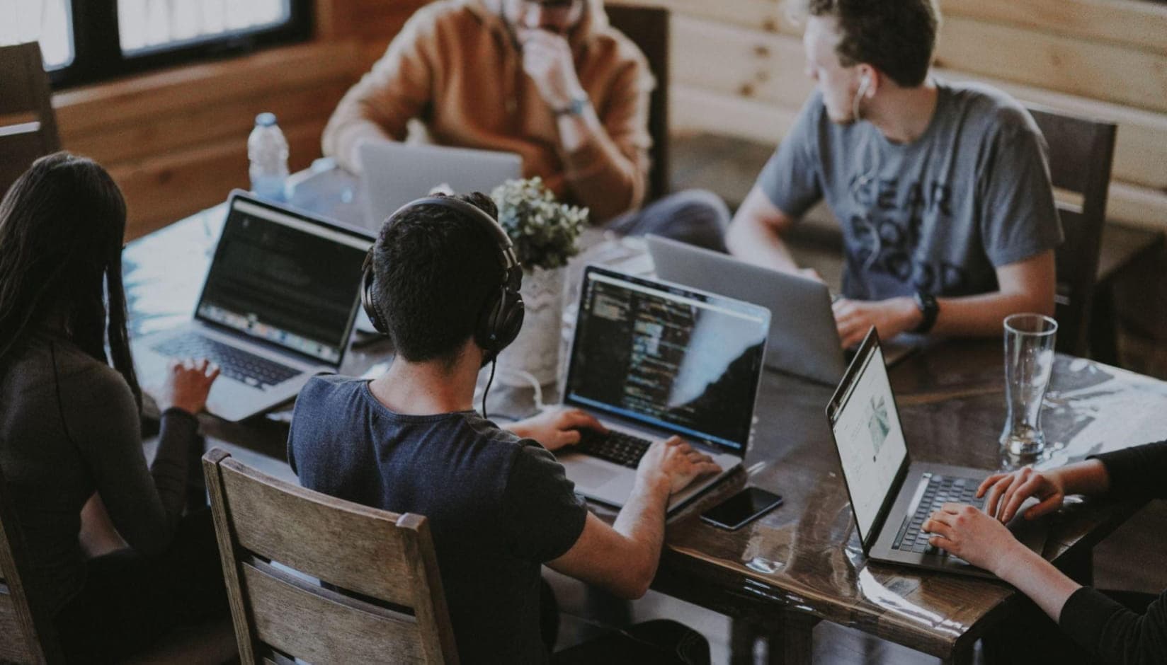 four residents sitting at the table at a coworking space