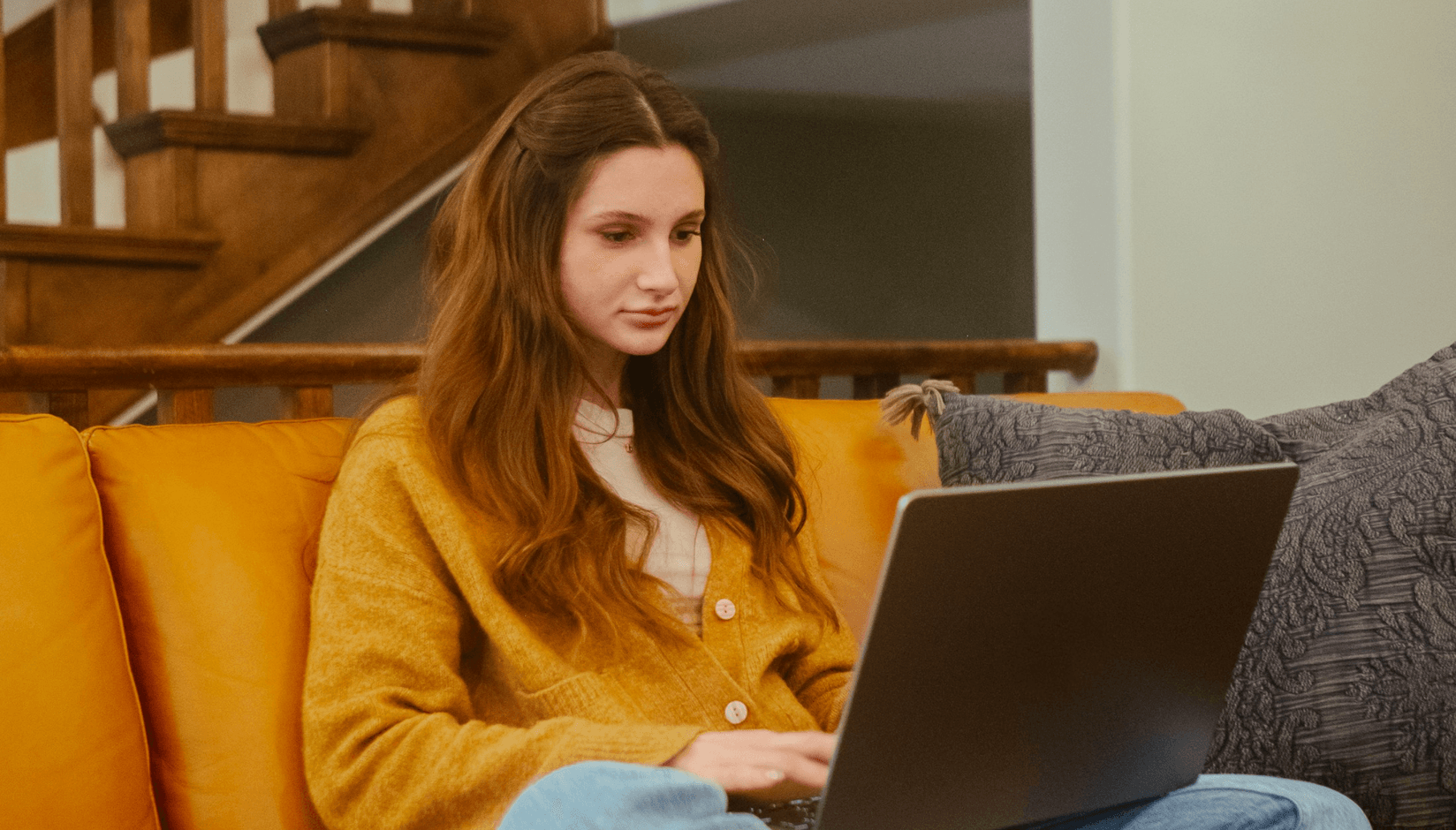 woman virtual coworking space member with laptop at the home door