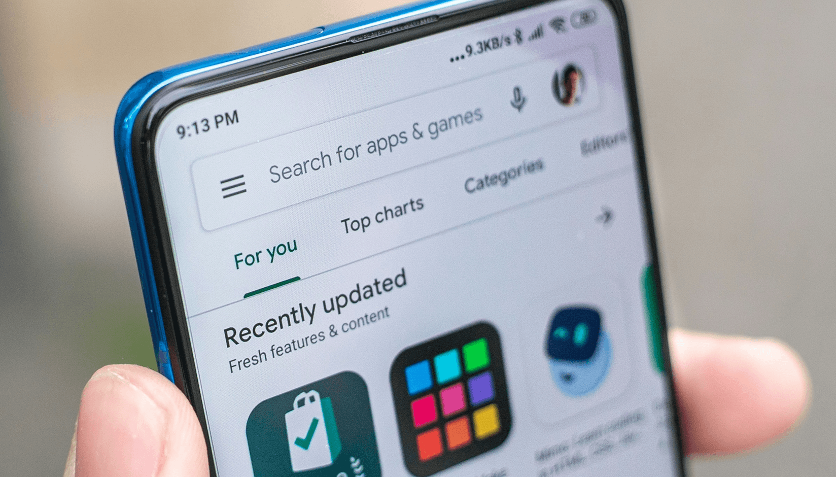 female hand getting ready to tap coworking space app on a smartphone