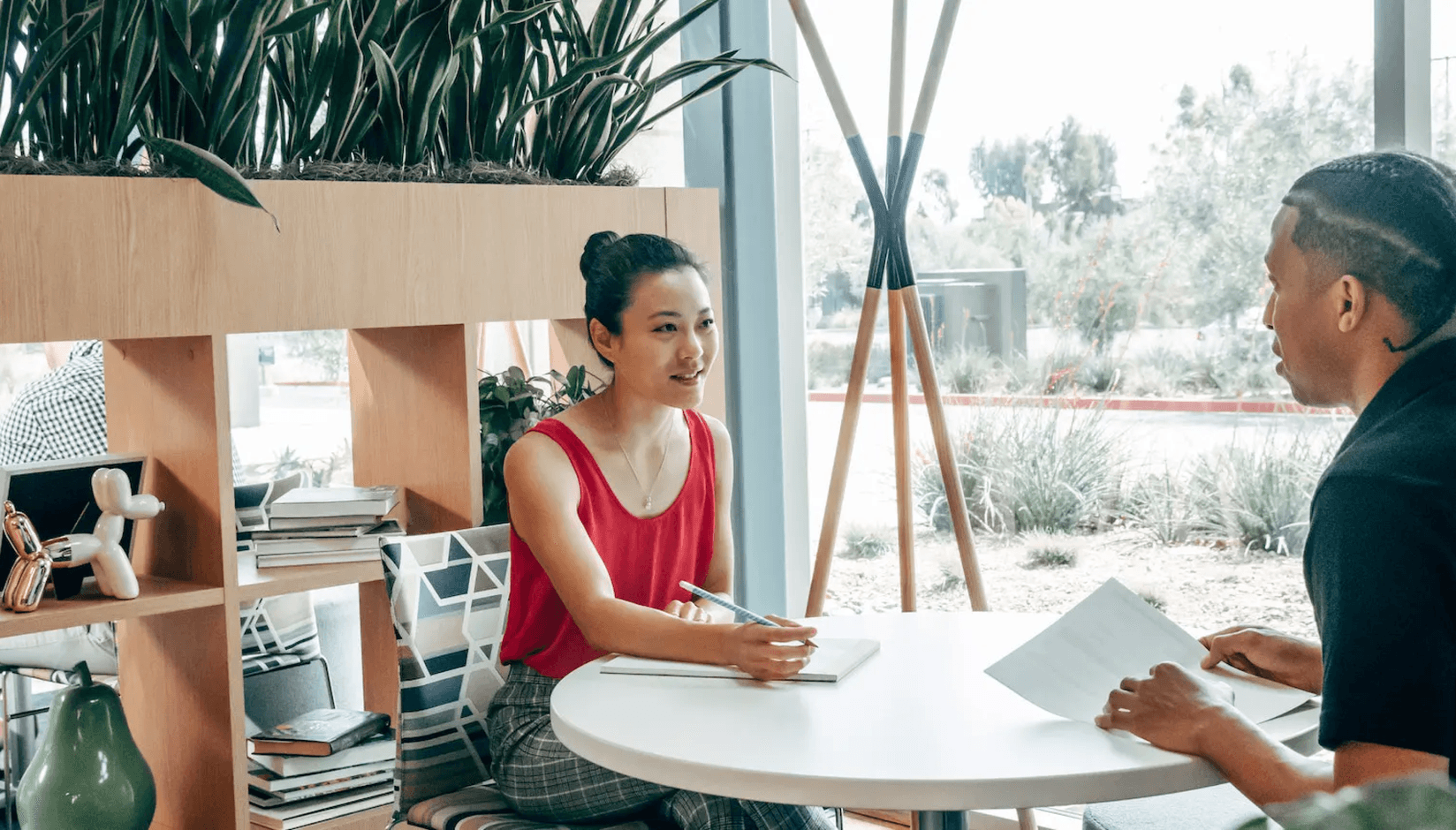 Coworking space managers discussing recurring revenue model